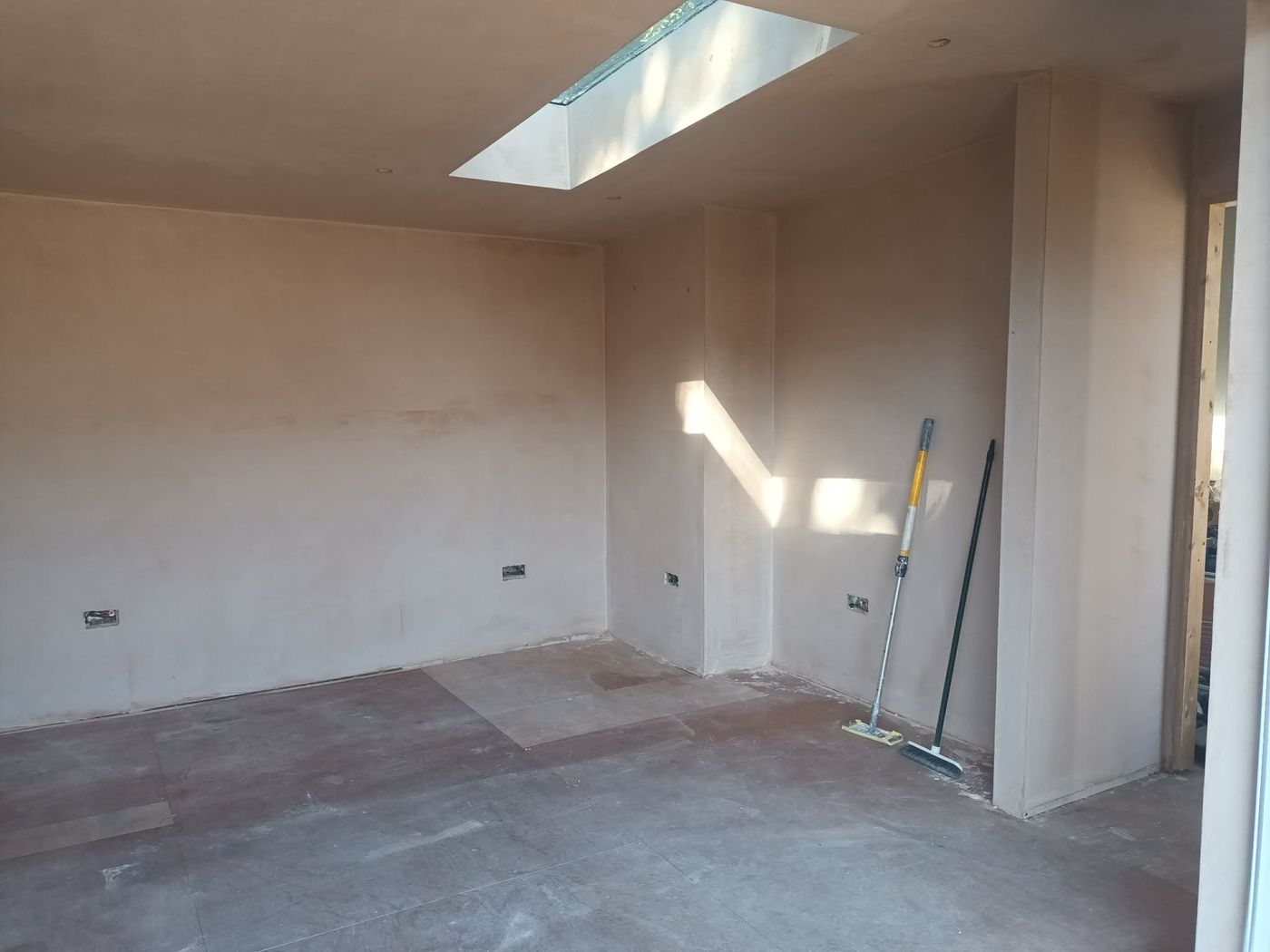 Bare plastered interior walls before spraying, roof light