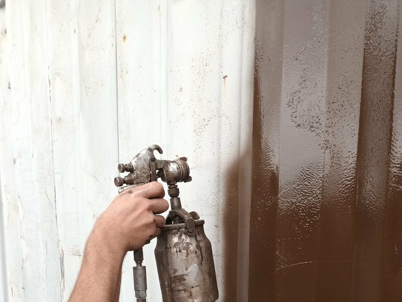 RPS Spraying technician spraying a corrugated panel on site